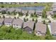 Aerial view of homes in a neighborhood with pond, showcasing the community layout and landscaping at 561 Farnham Dr, Westfield, IN 46074
