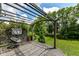 Relaxing back deck featuring a stylish pergola, a modern chair, and serene backyard views at 561 Farnham Dr, Westfield, IN 46074