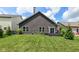 View of the backyard featuring a well manicured lawn, patio and mature trees at 561 Farnham Dr, Westfield, IN 46074