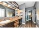 Stylish bathroom showcasing double sinks, decorative wood wall, and modern fixtures at 561 Farnham Dr, Westfield, IN 46074