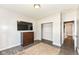 Bedroom featuring modern wood floors, a large window, a mounted tv, dresser, and closet at 561 Farnham Dr, Westfield, IN 46074