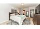 Well-lit bedroom showcasing a plush bed, decorative artwork, and access to a walk-in closet at 561 Farnham Dr, Westfield, IN 46074