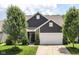 Charming home with a brown door, manicured lawn, and attached two-car garage on a sunny day at 561 Farnham Dr, Westfield, IN 46074