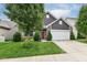 Charming home with a red door, manicured lawn, and attached two-car garage on a sunny day at 561 Farnham Dr, Westfield, IN 46074