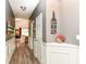 Hallway with white trim, wood floors, and decorative accents, leading to the living area at 561 Farnham Dr, Westfield, IN 46074