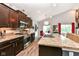 Contemporary kitchen with stainless steel appliances, granite countertops, and dark wood cabinetry at 561 Farnham Dr, Westfield, IN 46074