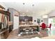 Modern kitchen with dark cabinets, stainless steel appliances, and island with seating flows to the dining area at 561 Farnham Dr, Westfield, IN 46074