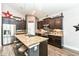 Modern kitchen featuring dark cabinetry, stainless steel appliances, and a stylish island with bar seating at 561 Farnham Dr, Westfield, IN 46074