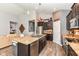Open concept kitchen features stainless steel appliances, dark cabinetry, and large center island at 561 Farnham Dr, Westfield, IN 46074