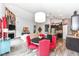 Open-concept living room with dining area, fireplace, vaulted ceilings, and modern furnishings at 561 Farnham Dr, Westfield, IN 46074