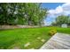 Expansive backyard with lush green grass, mature trees, a clothesline, storage shed, and partial fence, perfect for outdoor activities at 610 E 1000 N, Fortville, IN 46040