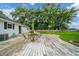 Inviting backyard deck with outdoor seating, overlooking a spacious lawn, mature trees, and a partially fenced yard at 610 E 1000 N, Fortville, IN 46040