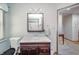 Bright bathroom with a dark wood vanity and mirror, featuring a toilet and wood-look flooring, maximizing space and style at 610 E 1000 N, Fortville, IN 46040