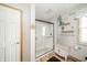 Modern bathroom with a glass-enclosed shower, decorative shelving, and wood-look flooring, offering a stylish and functional space at 610 E 1000 N, Fortville, IN 46040