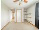 Neutral bedroom with a ceiling fan and a view into hallway at 610 E 1000 N, Fortville, IN 46040