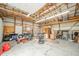 Spacious garage with exposed wood beams, ample storage space, and a concrete floor, suitable for various projects and equipment at 610 E 1000 N, Fortville, IN 46040