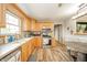 Well-lit kitchen with light wood cabinets, updated appliances, and wood look floors at 610 E 1000 N, Fortville, IN 46040