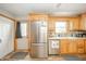 Bright kitchen featuring stainless steel appliances, light wood cabinets, and ample counter space at 610 E 1000 N, Fortville, IN 46040