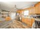 Kitchen with view of cabinetry and stainless refrigerator, and dining area at 610 E 1000 N, Fortville, IN 46040
