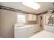 Practical laundry room with washer, dryer, cabinets, and ample counter space at 610 E 1000 N, Fortville, IN 46040