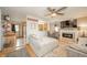 Open living space with ceiling fan, fireplace and hardwood floors next to kitchen at 610 E 1000 N, Fortville, IN 46040