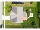 An aerial view shows the deck, firepit and manicured landscaping of the backyard at 6471 W Clearview Dr, McCordsville, IN 46055