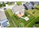 Aerial view of a well-maintained backyard featuring a patio, fire pit, and fenced yard at 6471 W Clearview Dr, McCordsville, IN 46055