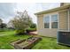 Landscaped backyard featuring raised garden beds and lush greenery, creating a serene outdoor space at 6471 W Clearview Dr, McCordsville, IN 46055