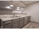 Basement bar with stylish cabinets, granite countertop, and modern pendant lighting at 6471 W Clearview Dr, McCordsville, IN 46055