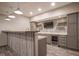 Custom basement bar with open shelving, a mini-fridge, and stylish accent lighting at 6471 W Clearview Dr, McCordsville, IN 46055