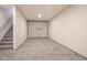 Finished basement area with plush carpeting, paneled accent wall, and stairway at 6471 W Clearview Dr, McCordsville, IN 46055
