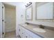 Bright bathroom featuring a double vanity with stone countertop and decorative framed mirrors at 6471 W Clearview Dr, McCordsville, IN 46055