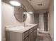 Bathroom with a large mirror, gray cabinets, and a tub-shower combination at 6471 W Clearview Dr, McCordsville, IN 46055
