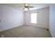 This bedroom has neutral carpet, a ceiling fan, and a window at 6471 W Clearview Dr, McCordsville, IN 46055