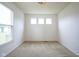 Bedroom featuring neutral carpet, three transom windows and a large window with blinds at 6471 W Clearview Dr, McCordsville, IN 46055