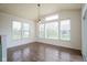 Dining area bathed in natural light with hardwood floors, modern lighting, and backyard view at 6471 W Clearview Dr, McCordsville, IN 46055