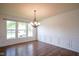 Elegant dining room with hardwood floors, wainscoting, a chandelier and large windows at 6471 W Clearview Dr, McCordsville, IN 46055