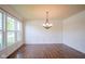 Elegant dining room with hardwood floors, wainscoting, a chandelier and large windows at 6471 W Clearview Dr, McCordsville, IN 46055