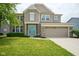 Charming two-story home featuring a manicured lawn, a two-car garage, and a welcoming turquoise-colored front door at 6471 W Clearview Dr, McCordsville, IN 46055