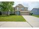Inviting two-story home with a well-manicured lawn and a spacious driveway at 6471 W Clearview Dr, McCordsville, IN 46055