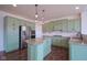 Eat-in kitchen with stainless steel appliances, granite countertops, green cabinets, and hardwood floors at 6471 W Clearview Dr, McCordsville, IN 46055