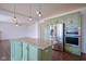 Kitchen island with granite countertop next to stainless steel fridge and double oven combo at 6471 W Clearview Dr, McCordsville, IN 46055