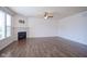 Bright living room featuring a stone fireplace, hardwood floors, and ceiling fan at 6471 W Clearview Dr, McCordsville, IN 46055