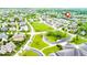 A high-angle view displays houses within the neighborhood and highlights an expansive green common area at 6691 Beekman Pl, Zionsville, IN 46077