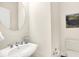 Stylish half bathroom features a white pedestal sink, a round mirror, a decorative painting, and a modern toilet at 6691 Beekman Pl, Zionsville, IN 46077