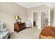 Bedroom showcasing neutral walls, plush carpet, a walk-in closet, and sitting area at 6691 Beekman Pl, Zionsville, IN 46077