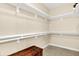 Walk-in closet offering ample storage with multiple shelves and a dark chest at 6691 Beekman Pl, Zionsville, IN 46077
