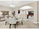 Open dining space with a glass table and views into other living spaces; light-filled interior at 6691 Beekman Pl, Zionsville, IN 46077