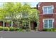 Charming brick home with lush landscaping, including a mature tree and manicured bushes at 6691 Beekman Pl, Zionsville, IN 46077