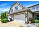 Three car garage with a well-maintained front yard and lovely shrubs at 6691 Beekman Pl, Zionsville, IN 46077